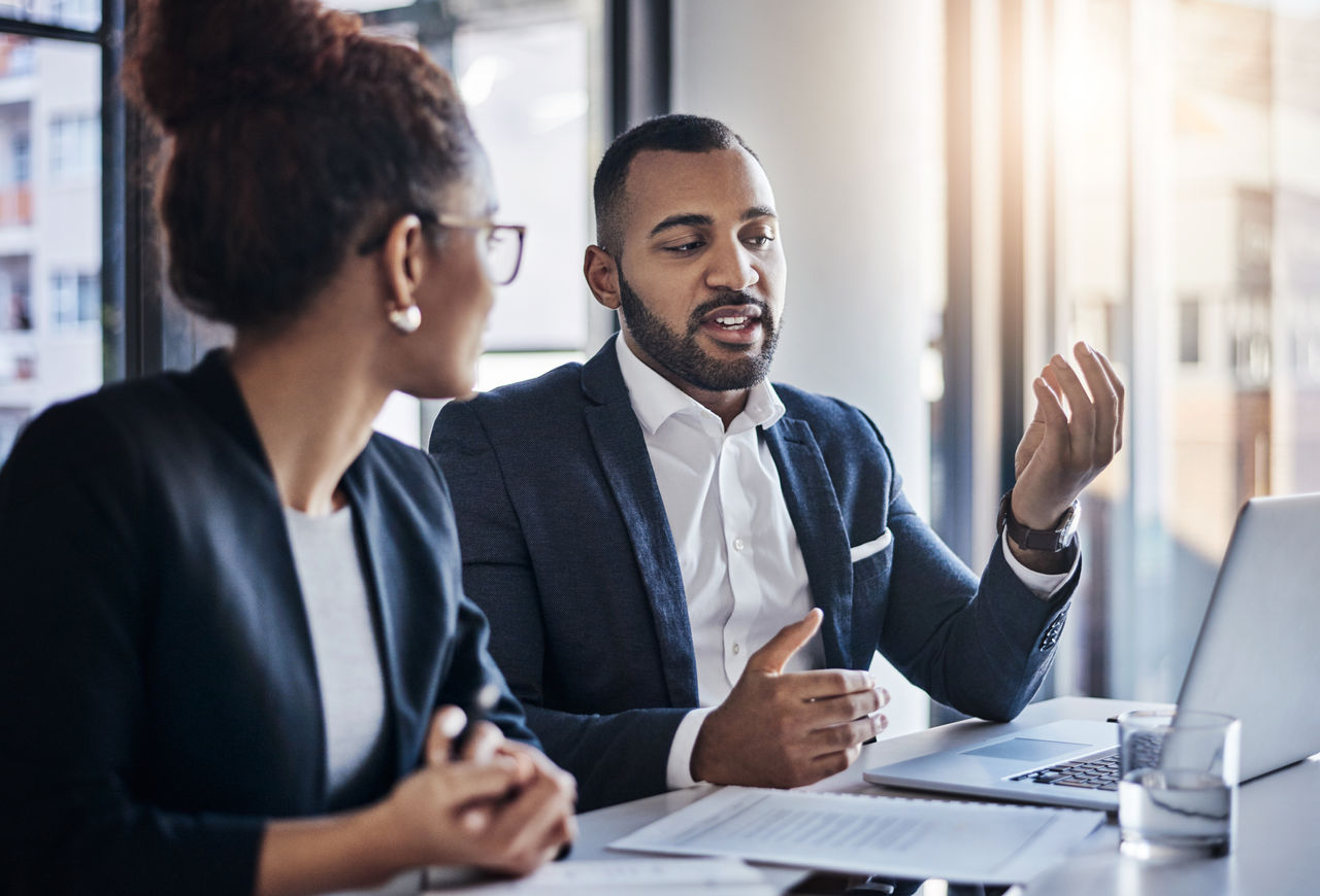 Shot of two businesspeople having a discussion in an office