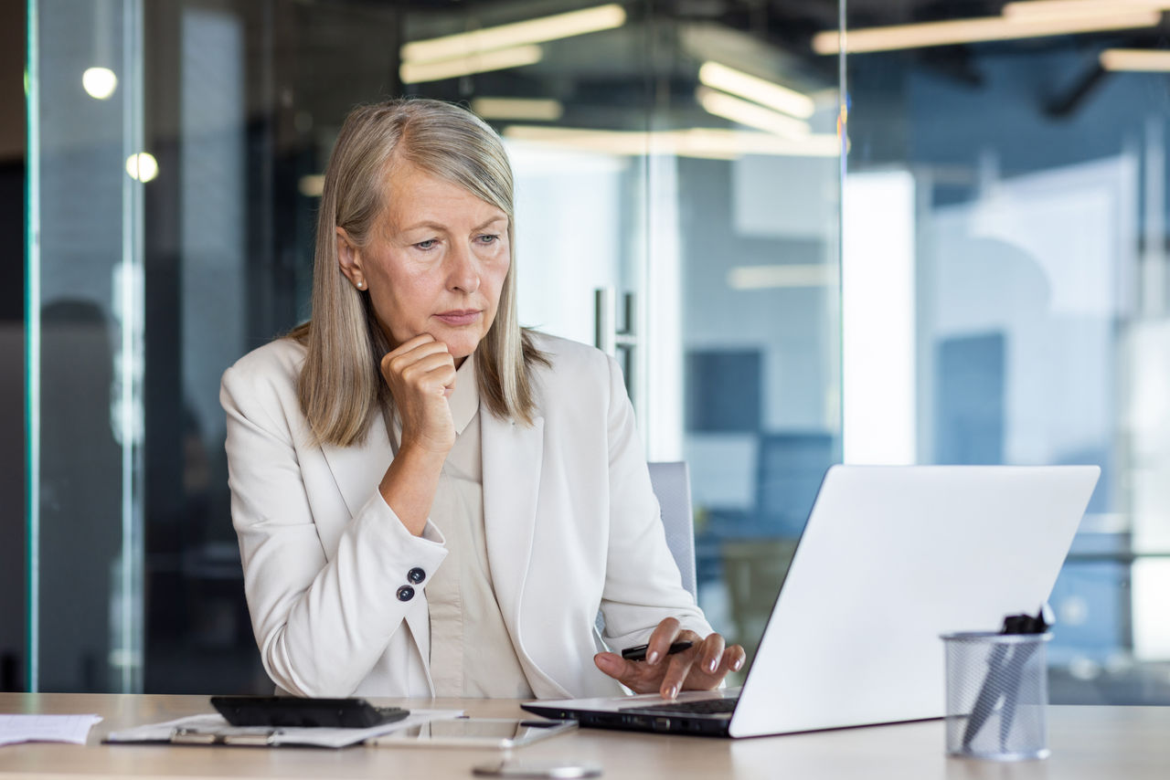 Focused woman working on laptop