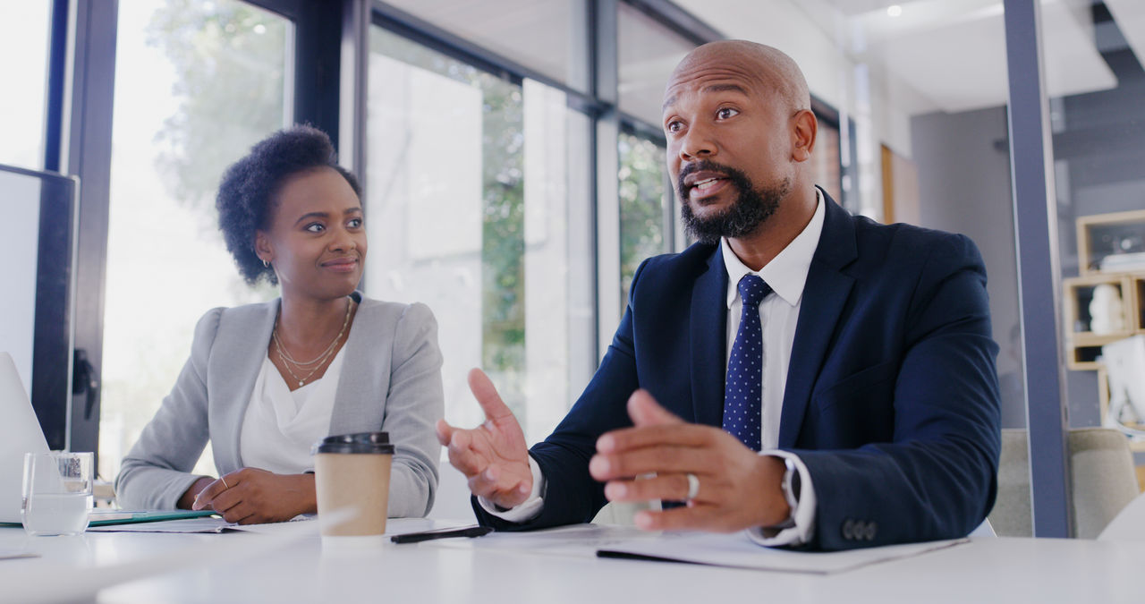 Cropped shot of businessman giving his opinion to his colleagues during a meeting in the office