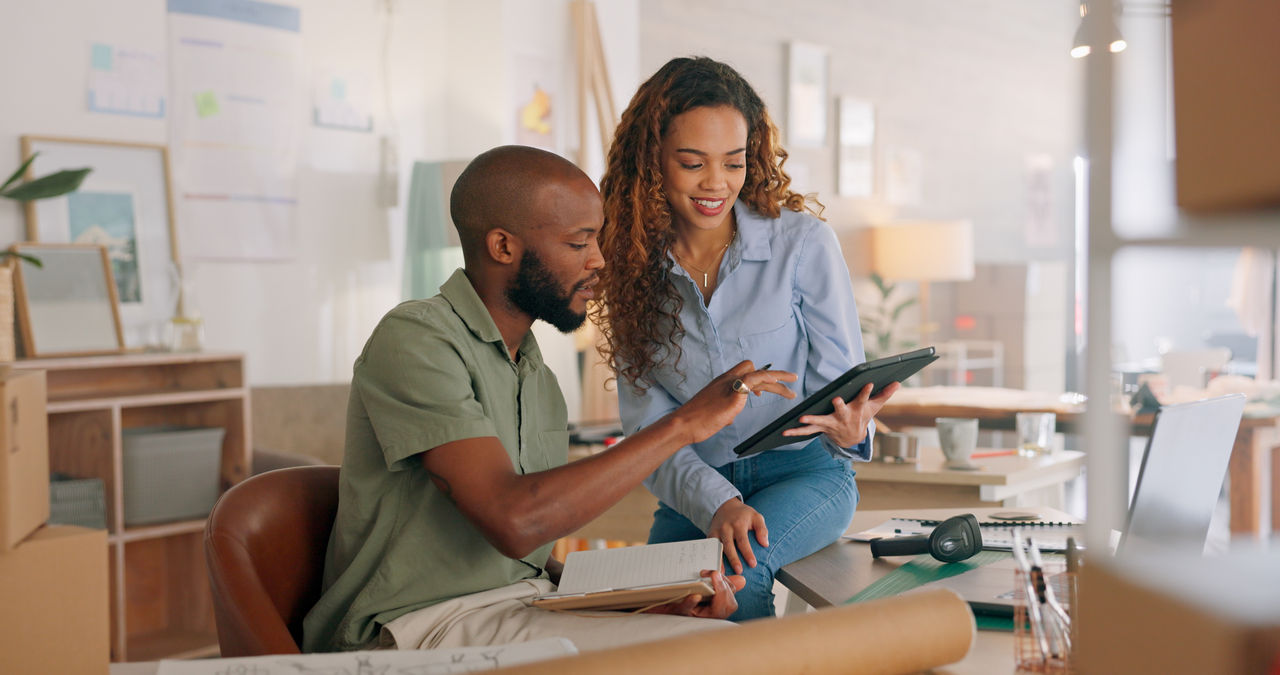 Startup company business owners looking at tablet